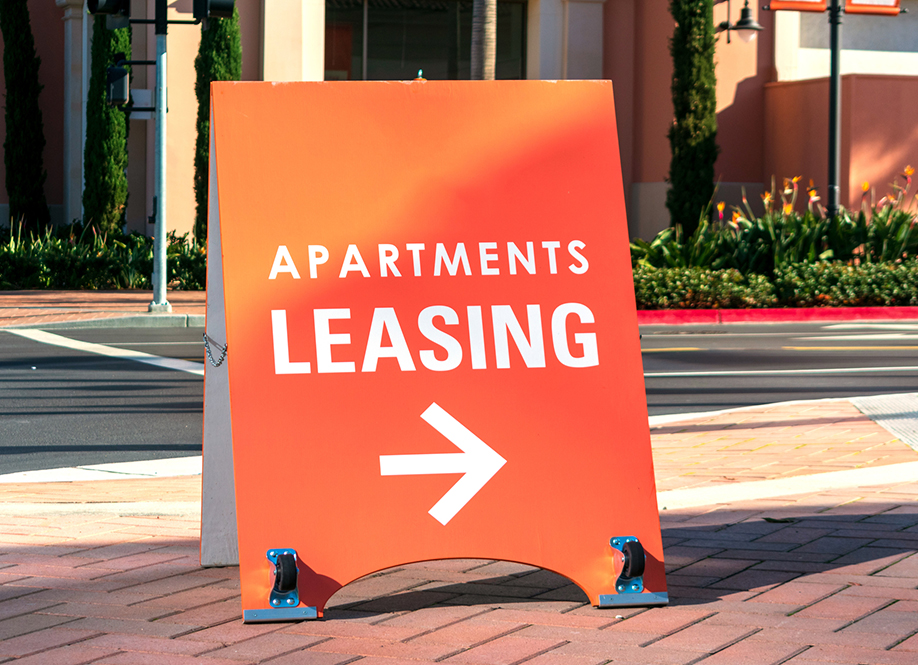 Apartment leasing sign promote the rental property and shows direction where the rental office is located